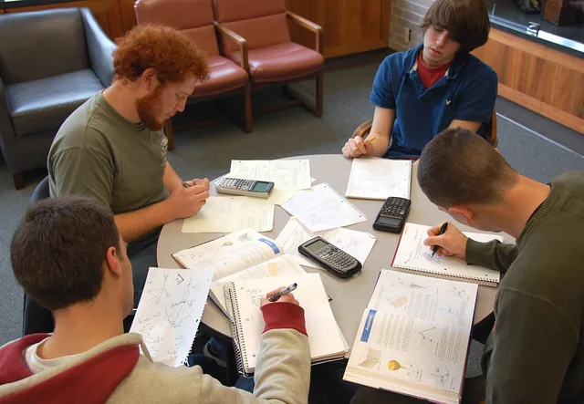 Four university students studying together at a table